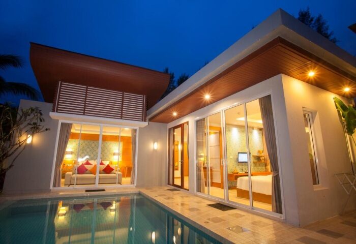 Apsara Beachfront Resort villa with pool at dusk. Modern architecture, illuminated rooms. Gay travel luxury accommodation. 137265538.jpg
