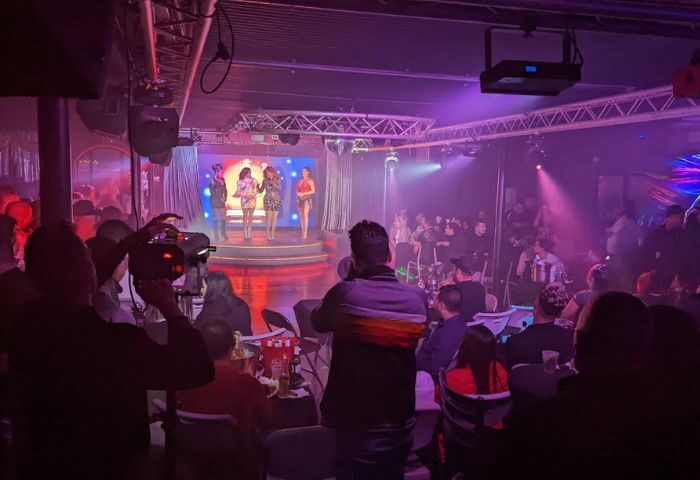 Azucar Nightclub: Drag show on stage with audience. Gay nightlife scene, purple lighting, and performers. Gay travel destination. 2-15.jpg