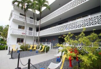 Gaythering Sauna: Exterior of the gay-friendly hotel with palm trees, chairs, and unique architectural details. Gay travel advice. 2-20.jpg