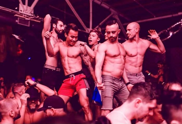 Gay men dancing shirtless at SCORE nightclub. Gay travel advice. Crowd of people, club lighting. 2-23.jpg.