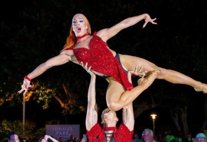 Drag show at Palace Bar. Two drag queens performing a lift, one in a red sequin dress, the other supporting. Gay travel advice.