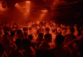 Crowd of men at a MENERGY party. Gay men's travel advice. Nightlife scene with red lighting. 22_menergy_03.jpg