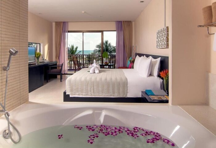 Apsara Beachfront Resort Villa room: bed, balcony view, and bathtub with flowers. Gay travel luxury stay in Thailand. 239190492.jpg