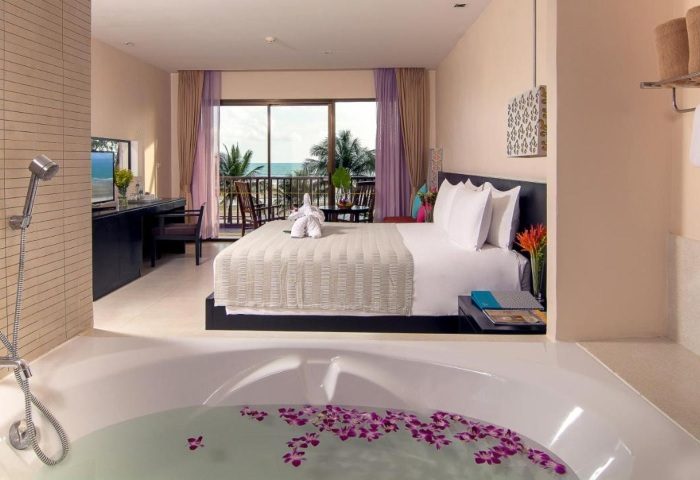 Apsara Beachfront Resort Villa room: bed, balcony view, and bathtub with flowers. Gay travel luxury stay in Thailand. 239190492.jpg