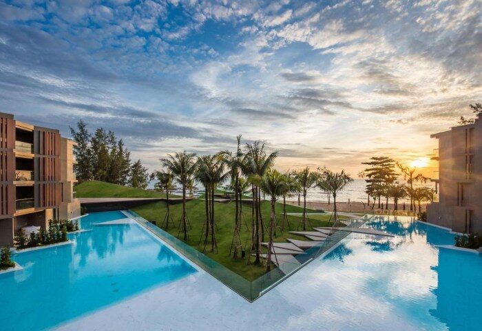 La Vela Khao Lak resort pool view. Tropical gay travel destination with palm trees, beach, and modern architecture. 259014358.jpg
