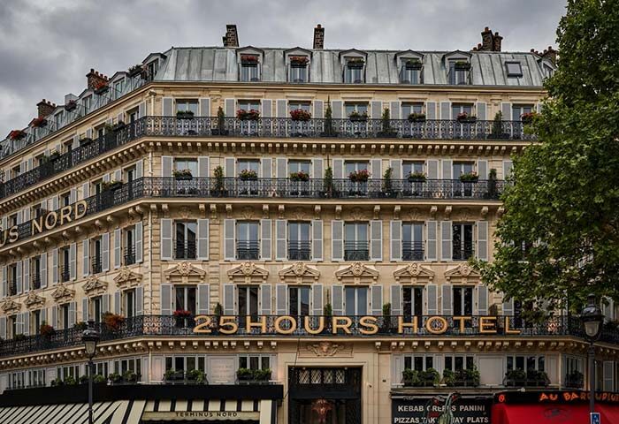 Facade of 25hours Hotel Terminus Nord, Paris. Gay-friendly hotel with balconies, shutters, and rooftop details. Parisian architecture.