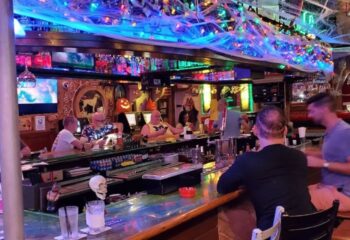 Mona's Cocktail Lounge interior. Gay bar with Halloween decor, men at the bar, and colorful lights. Gay travel in Key West. 3-10.jpg
