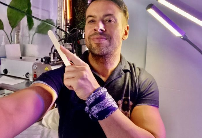 AlexSpot24: Gay man getting waxed. Male esthetician holding waxing stick. Grooming tips for gay travel. 3-21.jpg gay travel advice.