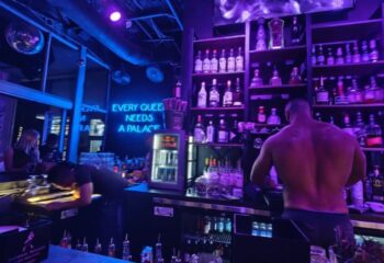 Palace Bar: A shirtless bartender works at this gay bar. Neon sign reads Every queen needs a palace. Nightlife at its finest! 3-24.jpg