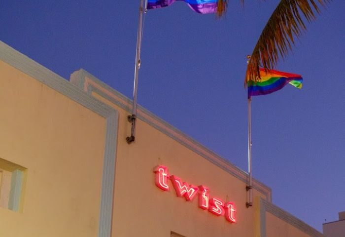 Twist gay bar building with rainbow flags. Miami Beach gay travel destination. Gay nightlife and LGBTQ+ scene. Twist neon sign.