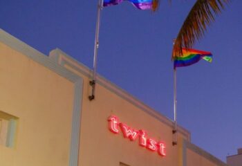 Twist gay bar building with rainbow flags. Miami Beach gay travel destination. Gay nightlife and LGBTQ+ scene. Twist neon sign.