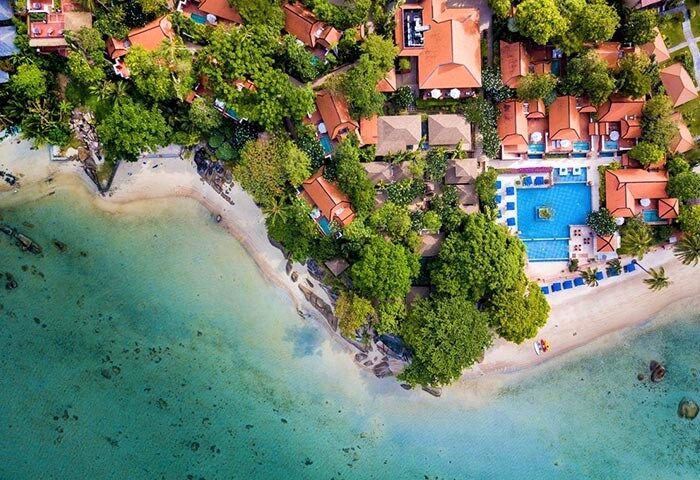 Renaissance Koh Samui Resort & Spa aerial view. Gay-friendly pool villas, beach, and lush greenery. Best gay travel destination in Thailand.