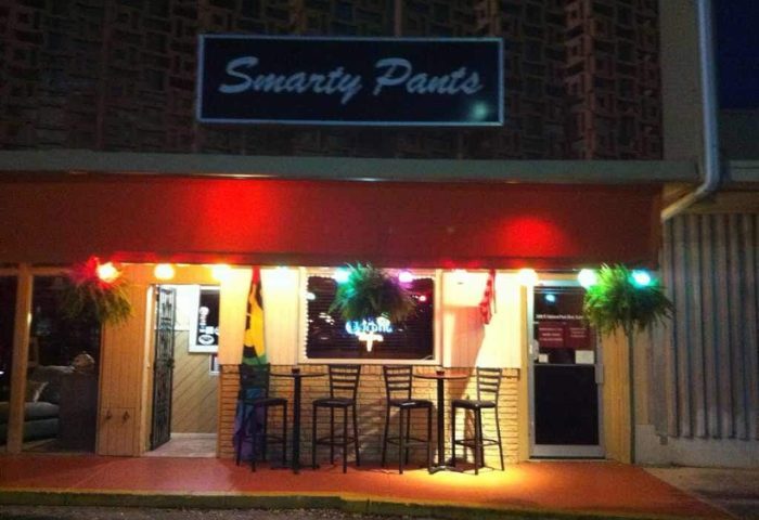 Smarty Pants Bar exterior. Gay bar entrance with rainbow flag, tables, and chairs. Night view of a travel destination. 3.jpg