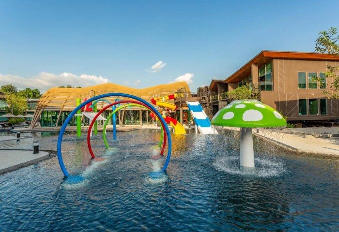Kalima Resort Khao Lak: Water park with slides, mushroom fountain, and colorful arches. A fun gay travel destination for relaxation and adventure.