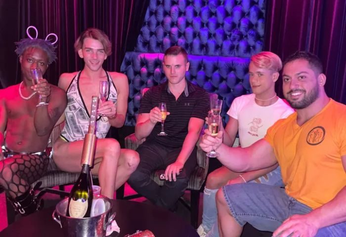 Five men toasting at a Boardwalk Bar. Champagne bottle in ice bucket. Gay travel nightlife. 4-11.jpg.