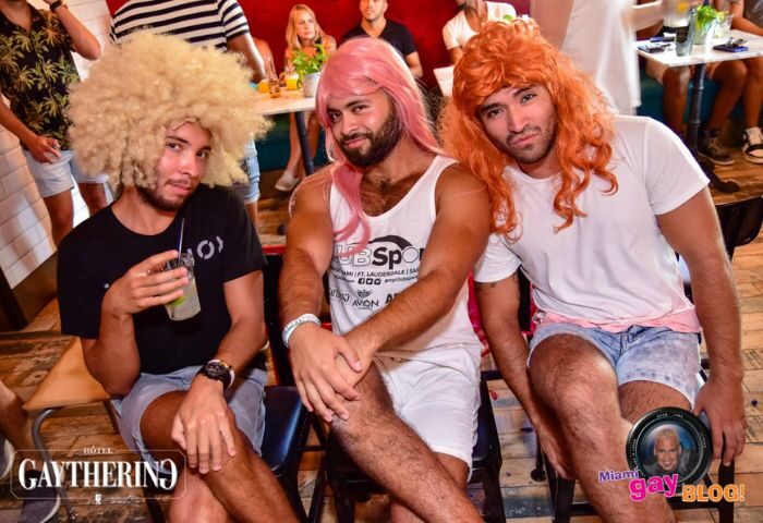Hotel Gaythering bar scene: Three men in colorful wigs pose at a party. Gay travel advice, fun, and nightlife. Miami Gay Blog.