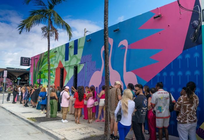 R House crowd. Miami's vibrant gay bar, R House, features colorful murals and a lively atmosphere. A popular spot for gay men's travel.