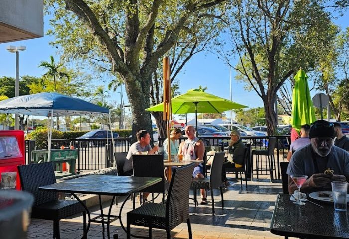 Georgie's ALIBI Monkey Bar outdoor patio. People at tables under umbrellas. Gay travel destination in Wilton Manors, Florida. 4-8.jpg