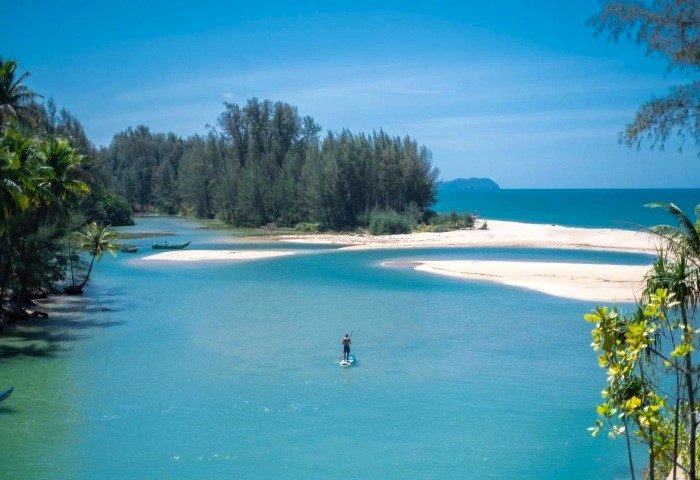 Devasom Khao Lak Beach Resort & Villas: Paddleboarder on turquoise water. Tropical gay travel at its finest. 495253927.jpg.