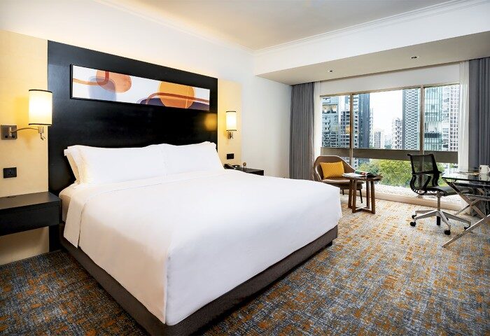 Deluxe high floor king bed at voco Orchard Singapore, an IHG Hotel. Modern room with city view. Perfect for gay travelers seeking comfort.