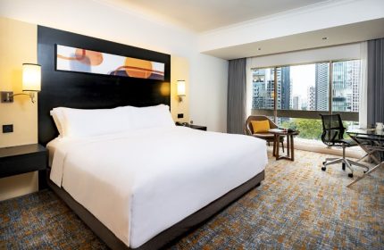 Deluxe high floor king bed at voco Orchard Singapore, an IHG Hotel. Modern room with city view. Perfect for gay travelers seeking comfort.