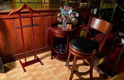 MuscleTech Bodywork Massage by Felix LMT: Interior with valet stand, table, flowers, and chair. Relaxing ambiance for gay men travel advice. 5-16.jpg