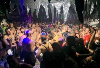 Crowded scene at The Eagle Wilton Manors, a gay bar. Men in harnesses and casual wear gather, creating a lively, social atmosphere. 5-8.jpg