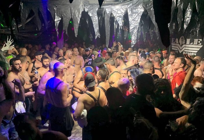 Crowded scene at The Eagle Wilton Manors, a gay bar. Men in harnesses and casual wear gather, creating a lively, social atmosphere. 5-8.jpg