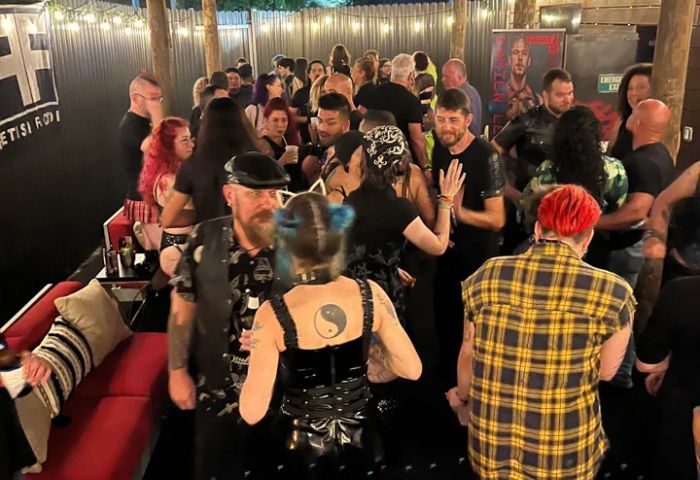 Boardwalk Bar: A lively crowd of gay men and others gather at the bar, some in leather, for a fun night out. Gay travel advice.