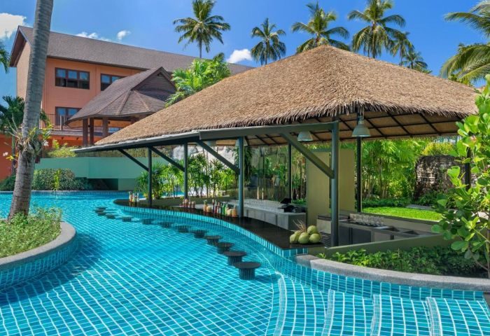 Courtyard Phuket Patong Beach Resort swim-up bar. Tropical gay travel destination with stools in the pool. Refreshments await!