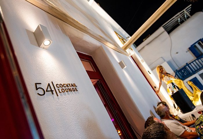 54 Cocktail Lounge & Skybar entrance in Mykonos. Live music, stylish design. Gay travel nightlife destination. LGBTQ+ friendly spot.