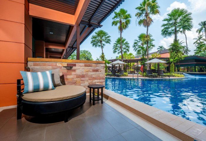 Courtyard Phuket, Patong Beach Resort view. Poolside lounge at 551900691.jpg. Gay travel to Thailand, luxury hotel, palm trees, relaxation.