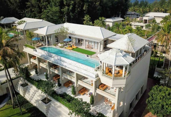 Devasom Khao Lak Beach Resort Sky Villa. Two-bedroom pool penthouse with rooftop pool, lounge areas, and lush tropical surroundings. Gay travel.