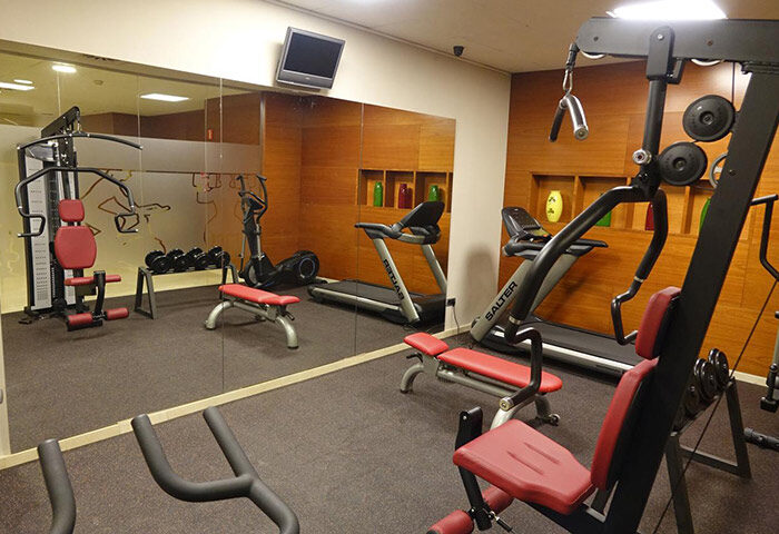 Acevi Villarroel Hotel gym in Barcelona. Treadmills, weights, and exercise machines. Most booked gay hotel with fitness center.