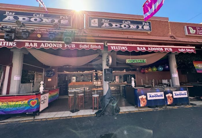 Adonis Bar, a gay bar in Gran Canaria. It's a popular spot with rainbow flags, serving cocktails and beer. A fun, welcoming place for gay travelers.