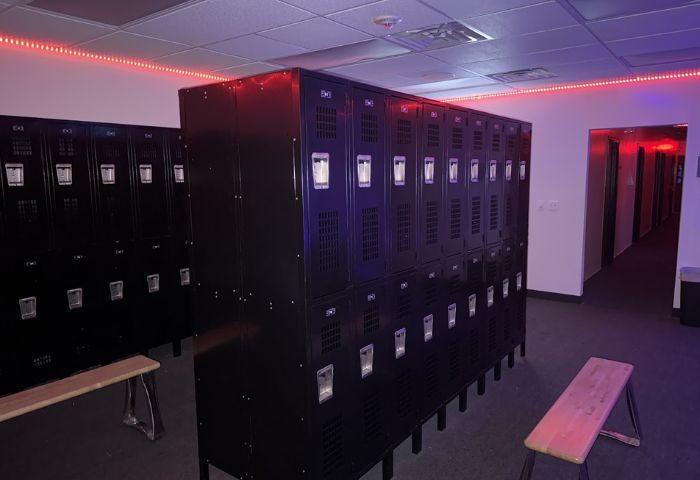 Adonis Health Club's locker room in Las Vegas. Black lockers line the walls, lit by red neon. Gay cruising spot.