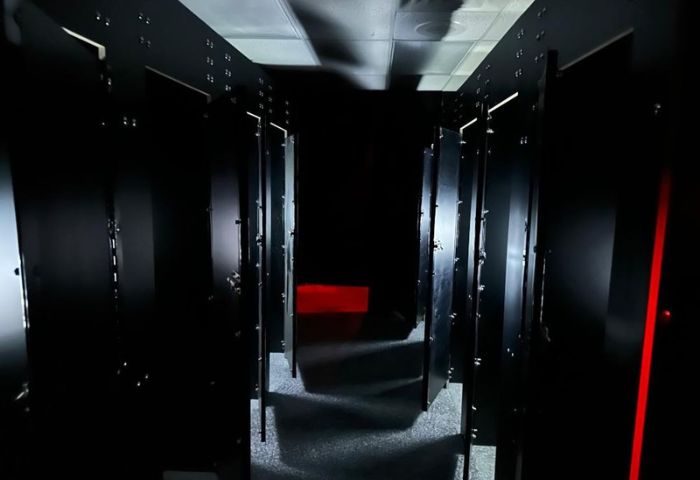 Dark hallway with stalls at Adonis Health Club, Las Vegas. Gay cruising spot. Red light in the distance. Travel advice.