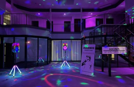 Adonis Health Club Las Vegas interior. Gay cruising spot with disco lights, dance floor, and multi-level layout. Gay travel advice.