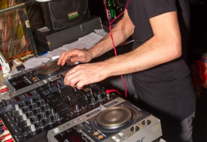 Afterline Milan: DJ spinning records at a gay party. Nightlife scene, music, and entertainment. Milan gay travel advice.