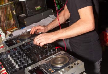 Afterline Milan: DJ spinning records at a gay party. Nightlife scene, music, and entertainment. Milan gay travel advice.