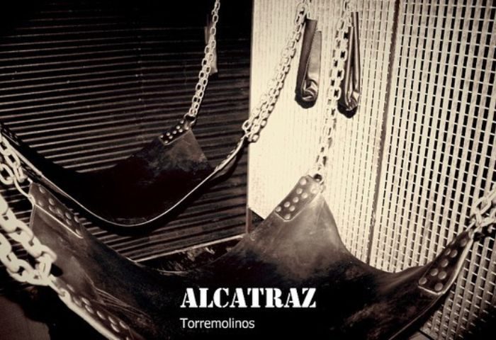 Alcatraz Men's Club in Torremolinos, Spain. Leather slings hang by chains. A popular gay cruise club for men's travel & nightlife.