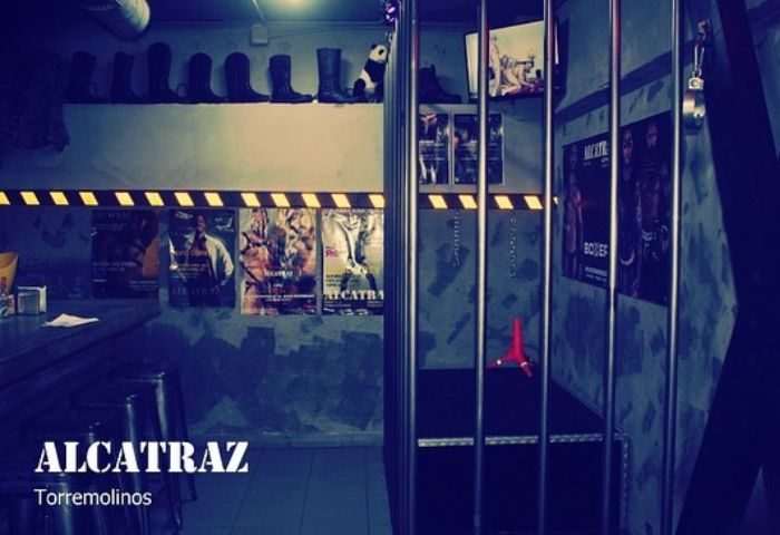 Interior of Alcatraz Men's Club, a gay cruise club in Torremolinos, Spain. Includes a cage, bar area, and suggestive decor. Nightlife.