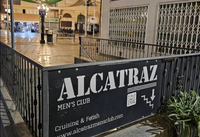 Entrance to Alcatraz Men's Club, a gay cruise club in Torremolinos. Sign with QR code and stairs down. Gay travel destination.