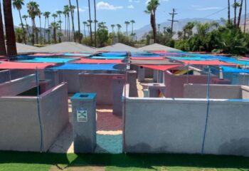 All-Worlds Resort gay rooms in Palm Springs. The clothing-optional maze at the gay resort, with colorful sunshades and desert landscaping.