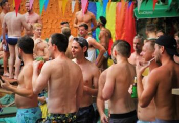 Alpha Gay Resort Koh Samui pool party. Gay men only hotel with shirtless men, drinks, rainbow flags, and tropical vibes.