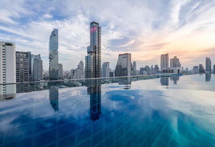 Amara Bangkok Hotel's infinity pool with city view. Gay-friendly hotel in Bangkok, Thailand. Perfect for gay men's travel.