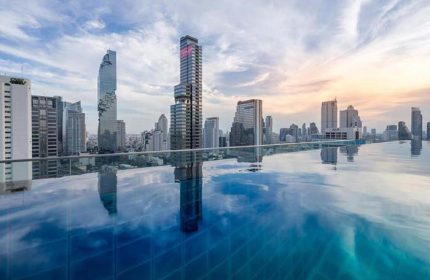 Amara Bangkok Hotel's infinity pool with city view. Gay-friendly hotel in Bangkok, Thailand. Perfect for gay men's travel.