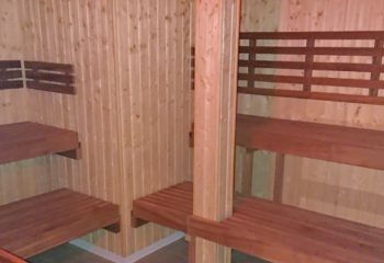Amigo Sauna Copenhagen interior. Wooden benches and walls create a warm atmosphere. Gay sauna for relaxation and socialising.