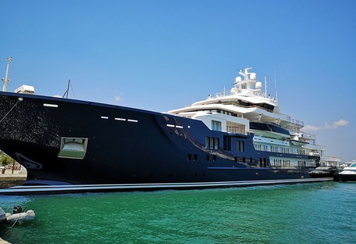 Luxury yacht in Ibiza. A large, multi-decked yacht is docked in the harbor, showcasing the upscale travel options available in Ibiza.