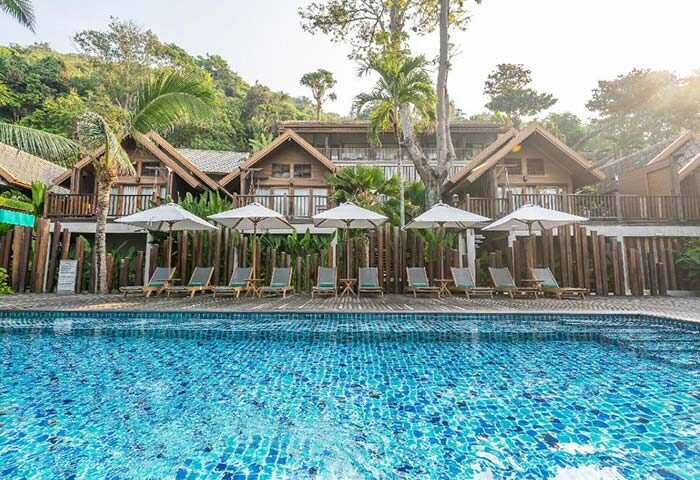 Ao Prao Resort, Koh Samet. Gay-friendly hotel pool view with sun loungers and umbrellas. Tropical paradise for gay travelers.